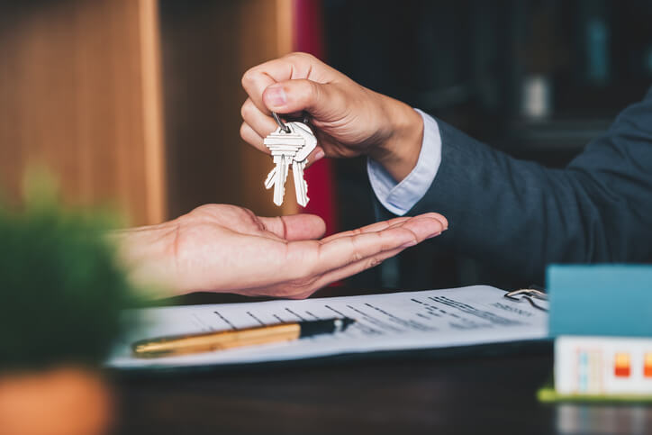 Home owner handing over keys to buyer