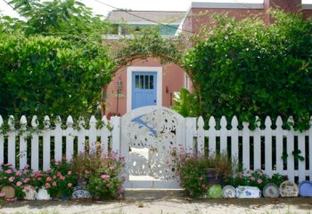 a white picket fence with a blue door