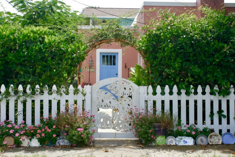 a white picket fence with a blue door